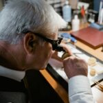 watchmaker examining watch